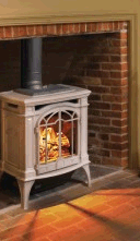 Gas stove within fireplace opening